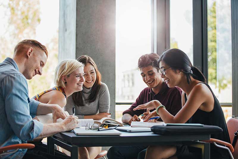 Friends at a table studying